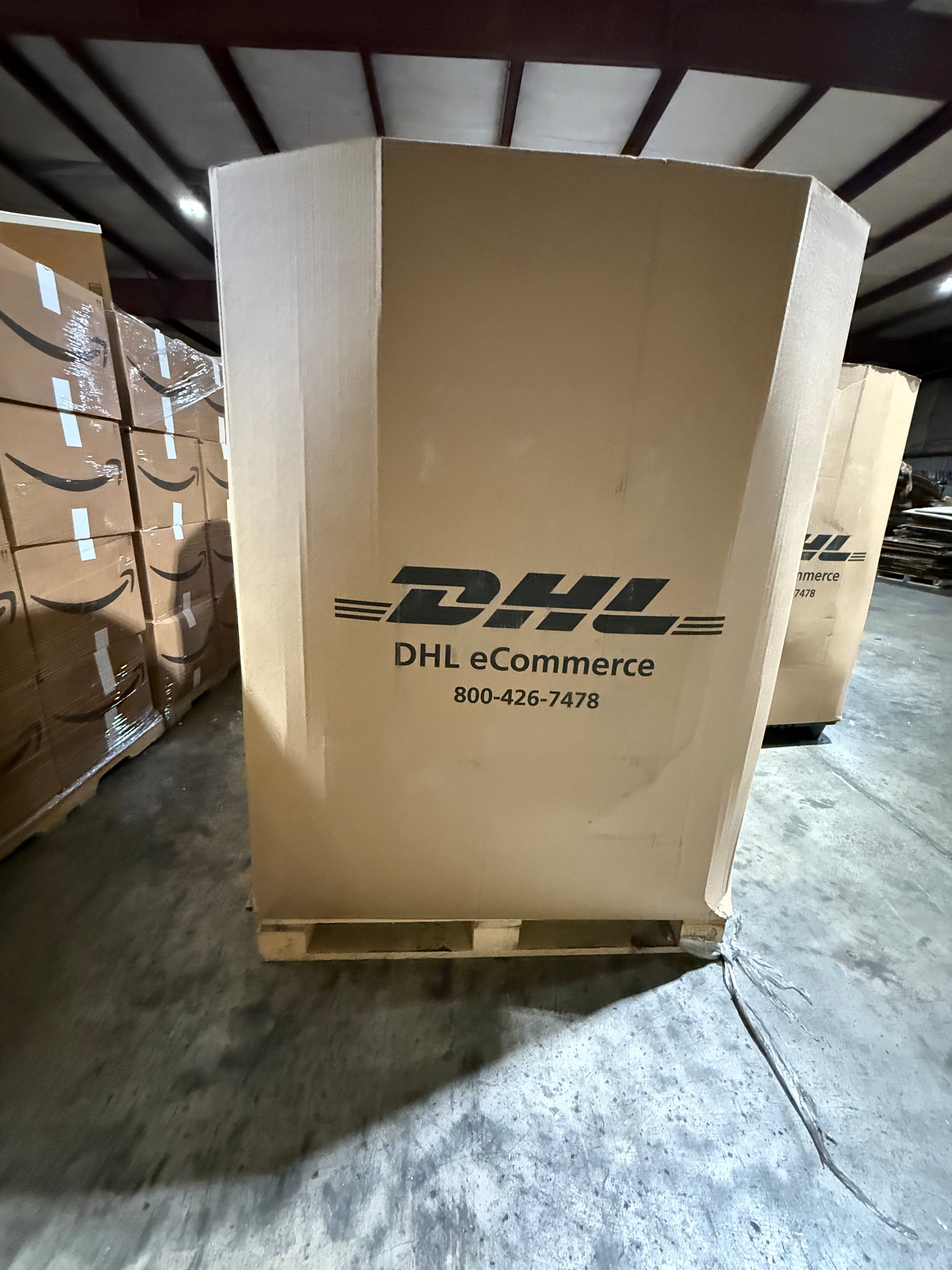 Large cardboard box with DHL logo in a warehouse setting
